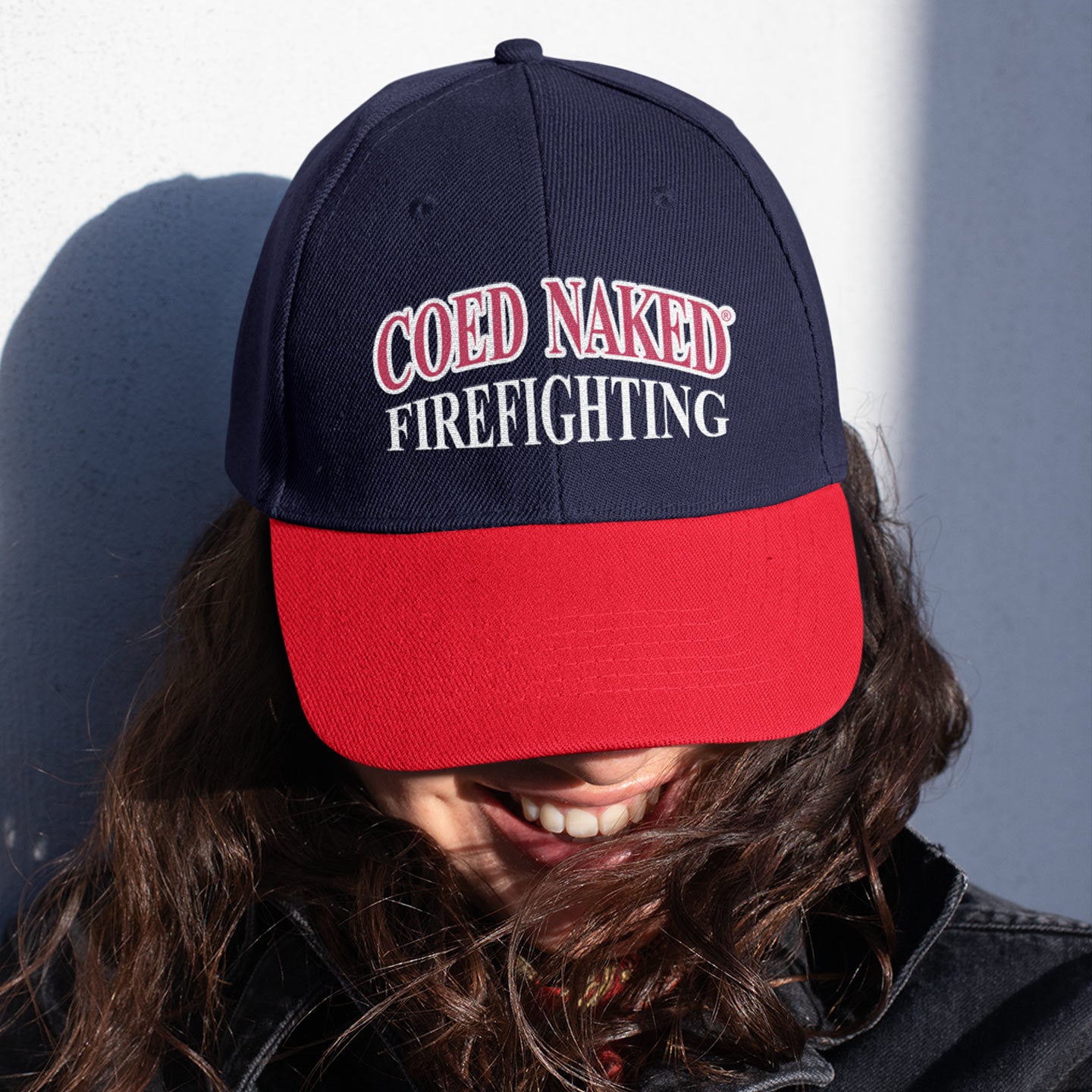 Coed Naked Firefighting Hat. Embroidered hat featuring the famous COED NAKED design. Model wearing it